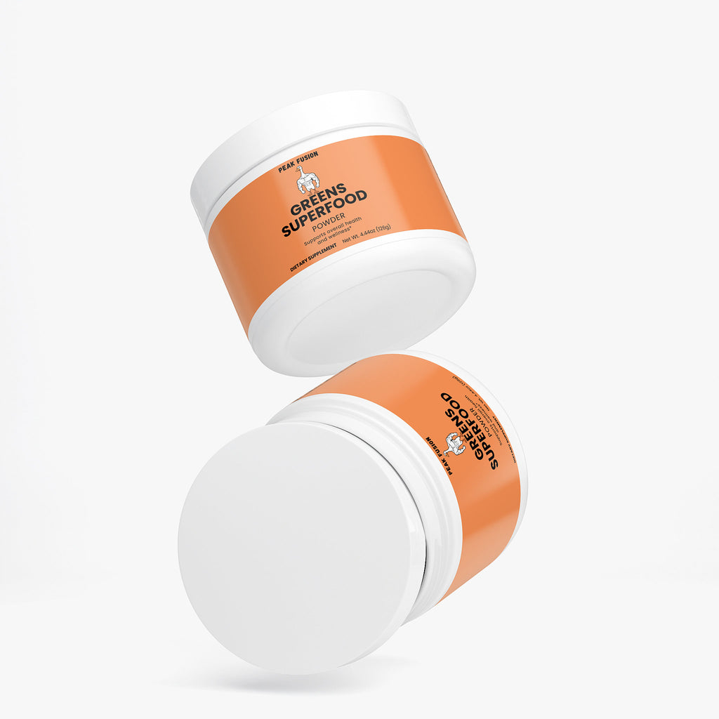 Two containers of 'Greens Superfood' on a white background